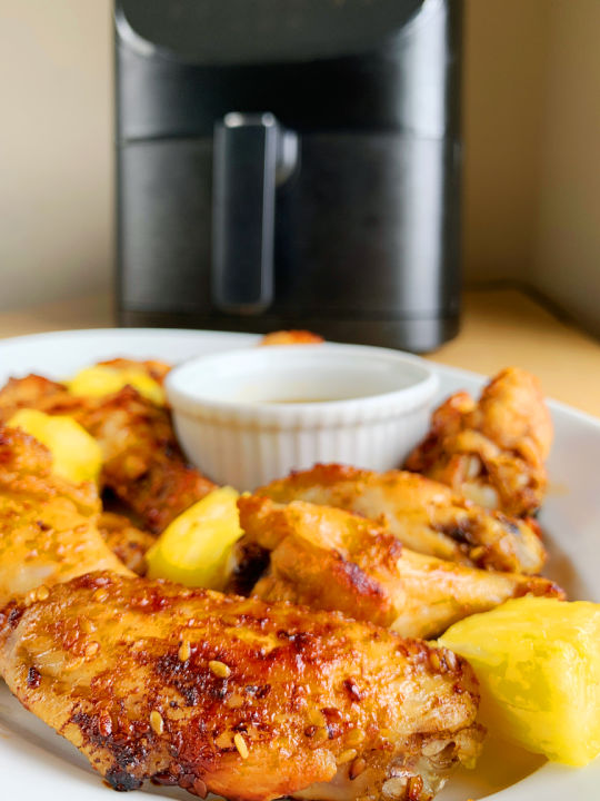 teriyaki wings with air fryer in background