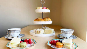 food on 3 tier cake stand with tea