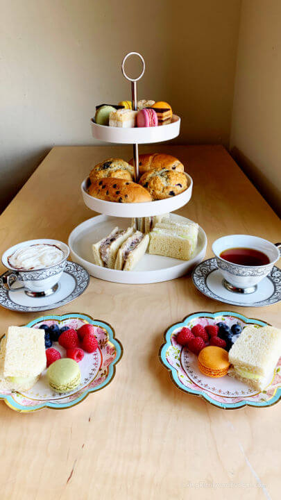 food on 3 tier cake stand with tea