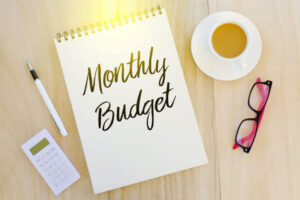 monthly budget on notebook and coffee