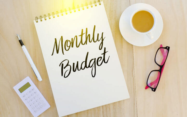 monthly budget on notebook and coffee