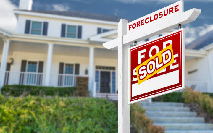 foreclosure sign in front of house