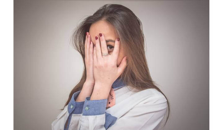 lady covering her eyes with hands