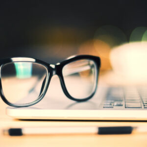 black glasses on laptop