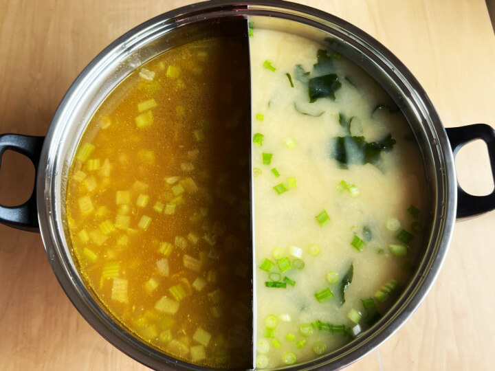 chicken soup and miso broth in separate sides of an electric pot