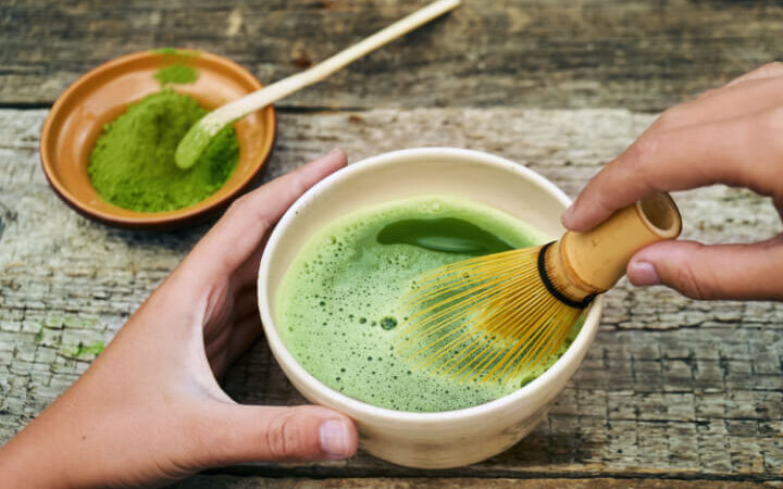 matcha in a cup being whisked