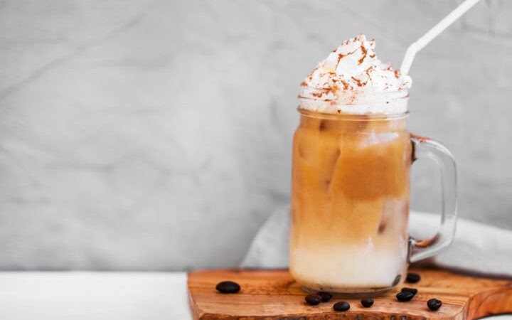 iced espresso drink in mason jar on wooden board