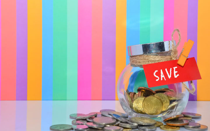 rainbow striped background, glass jar with money labeled savings