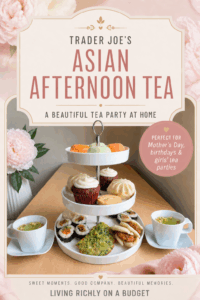 A tiered tray filled with Asian afternoon tea foods including mochi, cupcakes, bao, sushi, scallion pancakes, and tea, with text that reads “Asian Afternoon Tea at Home with Trader Joe’s.”